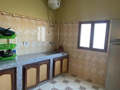 a kitchen with a sink and a window in it at Apartement Rachid in Merzouga