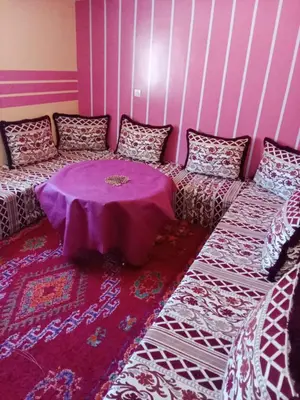 a room with a couch with a table in it at Gite entre les Vallées in Tacheddirt