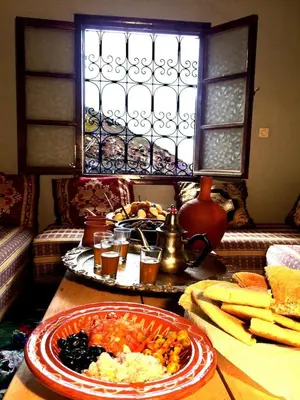 a table with a plate of food on a table at Gite entre les Vallées in Tacheddirt
