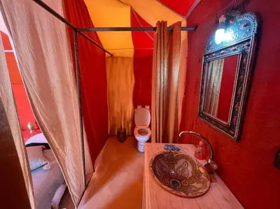 a small bathroom with a sink and a toilet at Local Luxury Camp in Merzouga