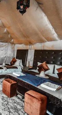 a room with two beds in a tent at Local Luxury Camp in Merzouga