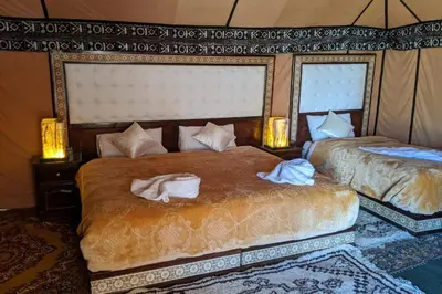 a bedroom with two beds with towels on them at Sahara Relax Camp in Merzouga