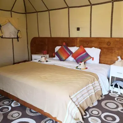 a bedroom with a large bed in a tent at Sahara Relax Camp in Merzouga