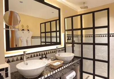 a bathroom with two sinks and a large mirror at Dar Lys Luxury Riad & Spa in Fès