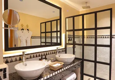 a bathroom with two sinks and a large mirror at Dar Lys Luxury Riad & Spa in Fès