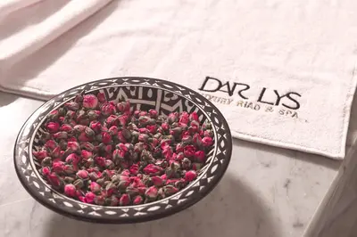 a bowl filled with pink flowers on a table at Dar Lys Luxury Riad & Spa in Fès