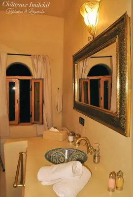 a bathroom with a sink and a mirror at Chateau Imilchil in Imilchil