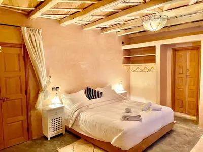 a bedroom with a large white bed in a room at Chateau Imilchil in Imilchil