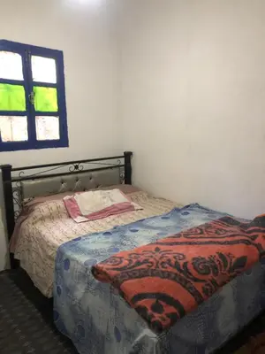 a bedroom with a bed with a blanket on it at Gite La belle vue Timichi in Timichi