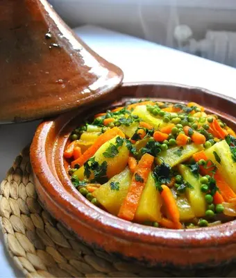 a bowl of food with carrots and other vegetables at Gite La belle vue Timichi in Timichi
