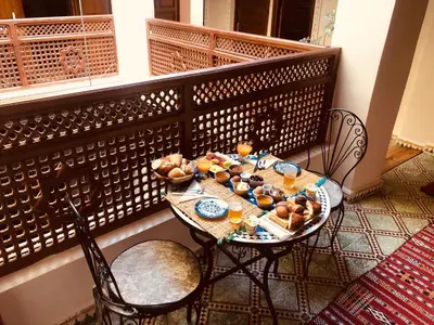 a table with food and drinks on a balcony at famille fahym in Fès