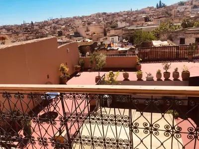 a balcony with a view of a city at famille fahym in Fès