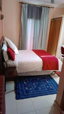 a small bed in a room with a window at Auberge Tourtite in Ifrane