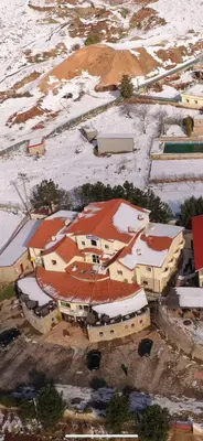 an aerial view of a building with snow covered roofs at Auberge Tourtite in Ifrane