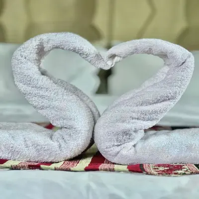 two heart shaped towels sitting on top of a bed at Riad Hassi Labied Merzouga in Merzouga