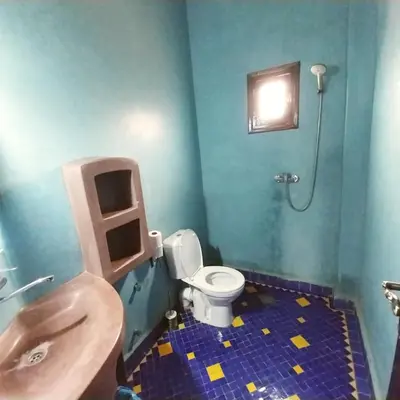 a bathroom with a toilet and a sink at Riad Hassi Labied Merzouga in Merzouga