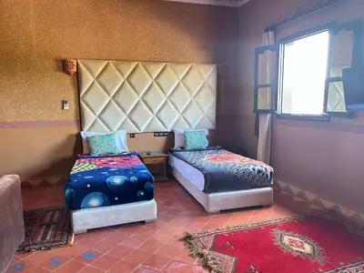 a bedroom with two beds and a window at Hotel Zagour - Luxury hotel in Zagora in Zagora