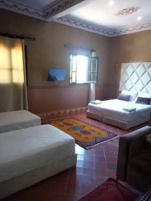 a living room with two beds and a couch at Hotel Zagour - Luxury hotel in Zagora in Zagora
