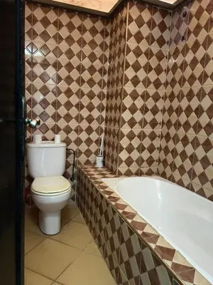 a bathroom with a toilet and a bath tub at Hotel Zagour - Luxury hotel in Zagora in Zagora