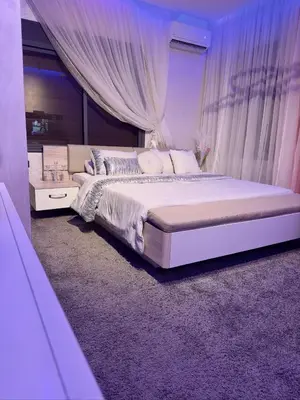 a large white bed in a room with curtains at la vue panoramique in Marrakech