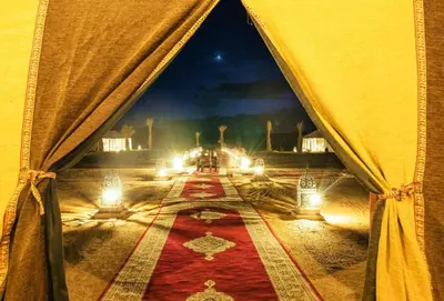a view from the inside of a tent with a red rug at Khadija Desert Camp in Merzouga