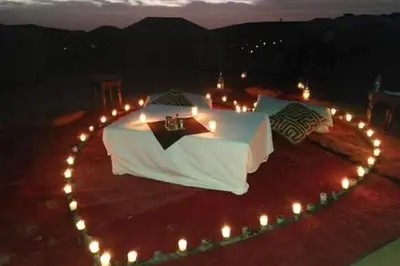a bed with lights in the shape of a heart at Khadija Desert Camp in Merzouga