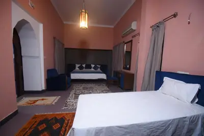 a hotel room with a bed and a bedroom at Kasbah Tifoultoute in Ouarzazate