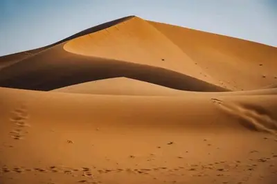 a sand dune in the middle of a desert at Desert Erg Chigaga Lodge in El Gouera