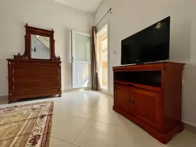 a living room with a flat screen tv on a wooden entertainment center at Magnifique villa - 5 chambres - Ifrane in Ifrane