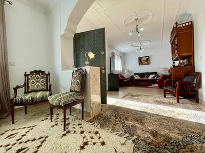 a living room with two chairs and a couch at Magnifique villa - 5 chambres - Ifrane in Ifrane