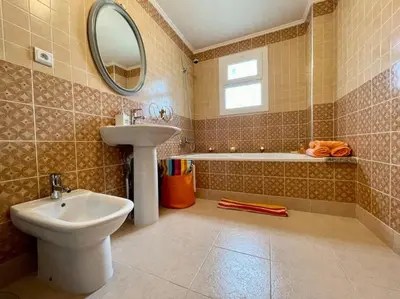 a bathroom with a sink and a toilet and a tub at Magnifique villa - 5 chambres - Ifrane in Ifrane