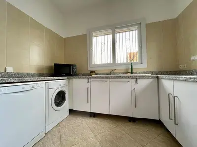 a kitchen with a washing machine and a sink at Magnifique villa - 5 chambres - Ifrane in Ifrane