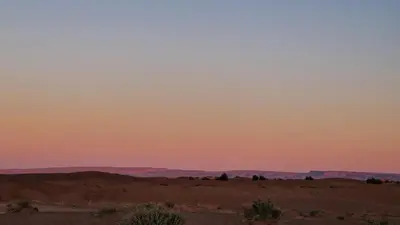a view of the desert at sunset at Sahara Authentic Berber Camp in Mhamid