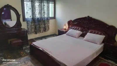 a bedroom with a large bed and a mirror at Villa familys in Fès