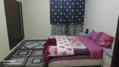 a bedroom with a bed and a dresser at Villa familys in Fès