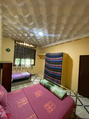 a room with two beds and a couch at Villa familys in Fès