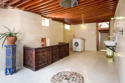 a bathroom with a sink and a washing machine at House in the old Medina of Fez in Fès al Bali