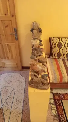 a stack of rocks sitting on a table in a room at Chez L'habitant Brahim kanih in Anzel