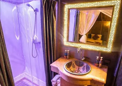 a bathroom with a sink and a mirror at Amazing Desert Luxury Camp in Merzouga