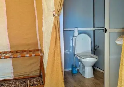 a small bathroom with a toilet in a room at Amazing Desert Luxury Camp in Merzouga