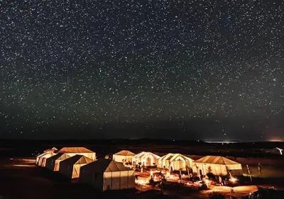 a group of tents under a starry sky at night at Amazing Desert Luxury Camp in Merzouga
