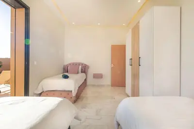 a bedroom with two beds in a room at Villa Hawai, ss vis à vis avec espace de sport , piscine Chauffée in Marrakech