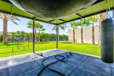 a view from the inside of a house with palm trees at Villa Hawai, ss vis à vis avec espace de sport , piscine Chauffée in Marrakech