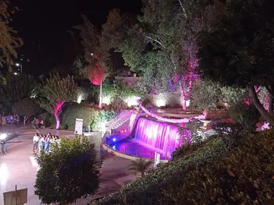 a fountain in a park at night with lights at Appartement Ain Asserdoun in Beni Mellal