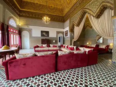 a large living room with red couches in a room at Youssef in Fès