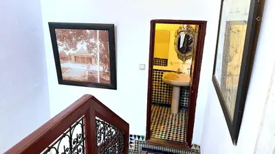 a bathroom with a sink and a mirror on a wall at Youssef in Fès