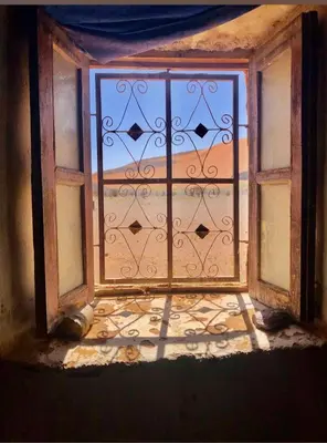 an open window with a view of the desert outside at Auberge Hassi Fougani in Tafraoute Sidi Ali