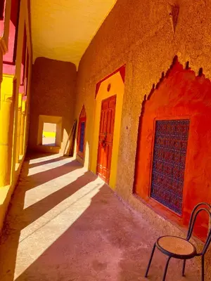 an empty alley with a table and a chair in a building at Ryad lcaid in Tissint