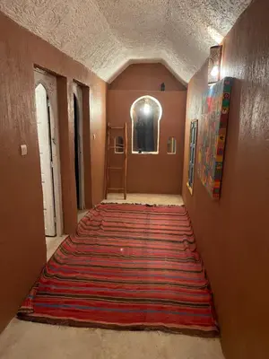 a hallway with a large rug on the floor at Ryad lcaid in Tissint