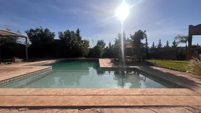 a swimming pool with a light pole in a yard at Escapade famille - vue panoramique et piscine privée in Aït Ghemat